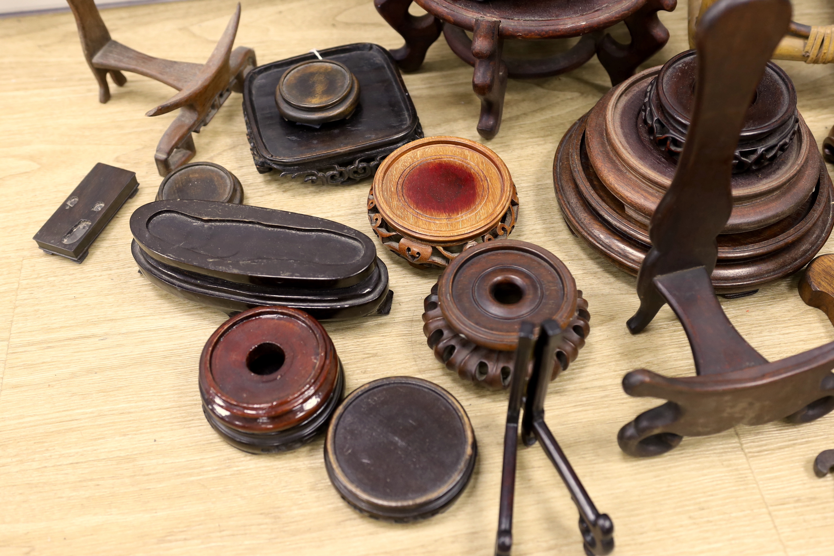 A collection of Chinese carved wooden stands and a small bamboo stand